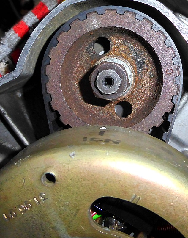 Timing marks alignment on rotor, camshaft centreline and parallel lines on trigger coil.