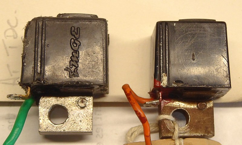 Original trigger coil on right. Replacement on left. <br />Parallel moulded timing marks in casing.