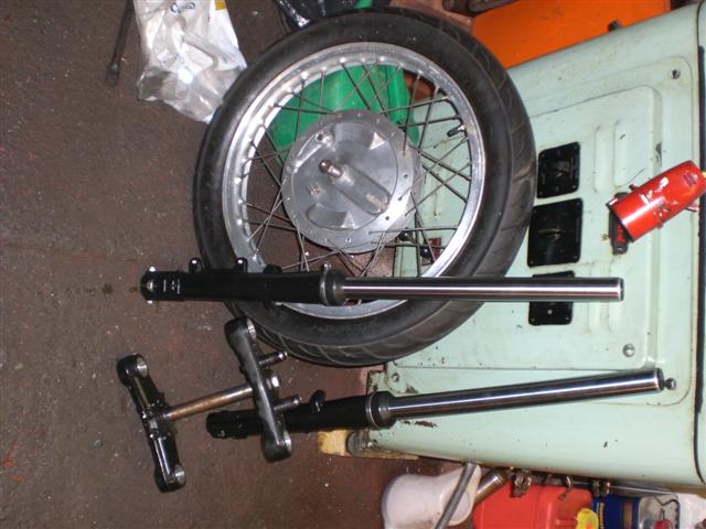 originally i was gonna use a set of ducati single forks and front wheel then i decided to upgrade to a new set of paioli forks for a pantah that i bought of ebay for £99 inc' yokes! i stripped of the paint and removed the caliper mounts
